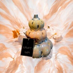 Stack of three light up iridescent pumpkins. One is white one is pink-lt purple.